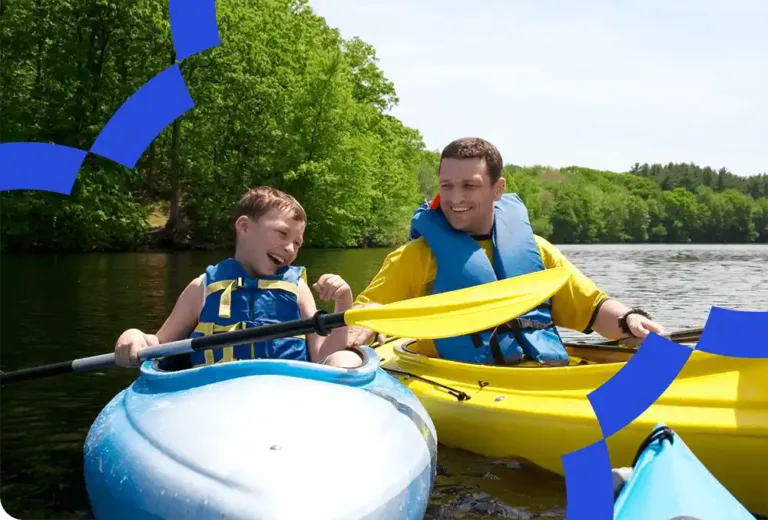 Father and son paddling in canoes